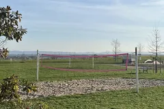 Campo de voleibol exterior com a rede montada e as linhas marcadas no piso